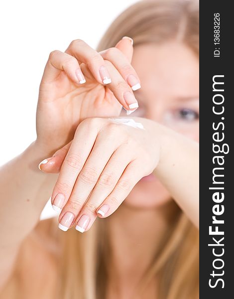 Caucasian blonde woman creaming hands