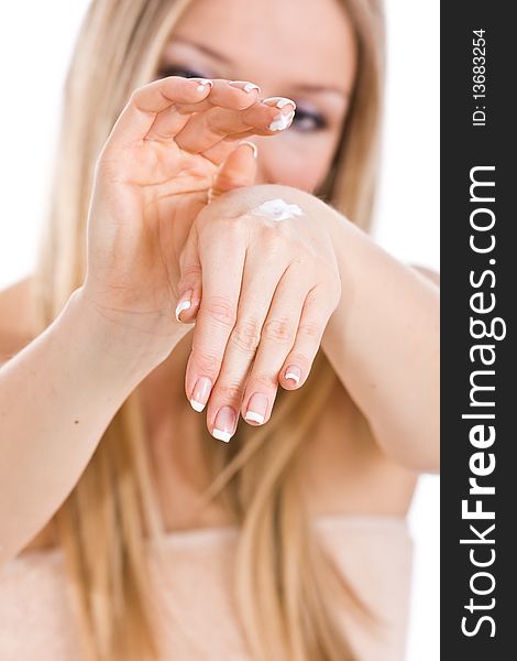 Caucasian blonde woman creaming hands