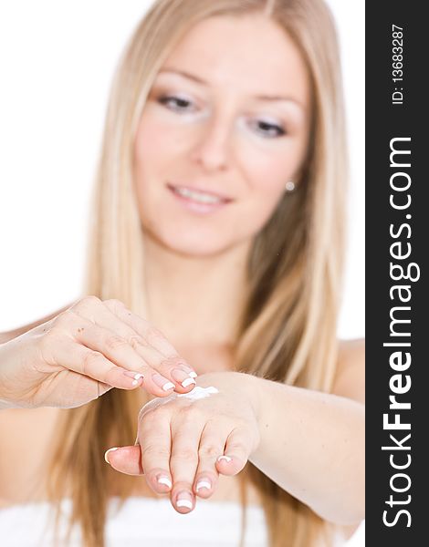 Caucasian blonde woman creaming hands