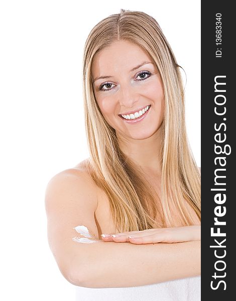 Caucasian blonde woman creaming arm