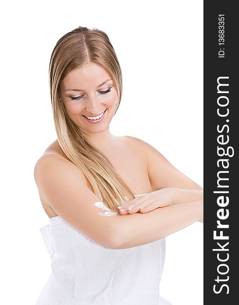 Caucasian blonde woman creaming arm