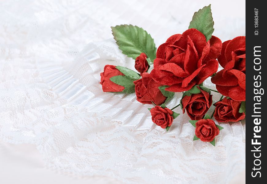 Closeup shot of red paper flowers on white background