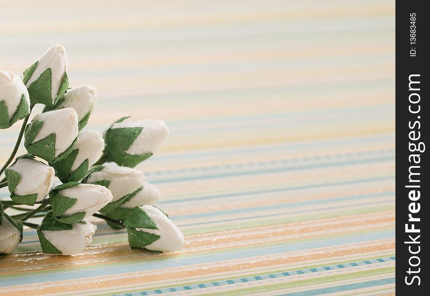 Closeup shot of white paper flowers on light background