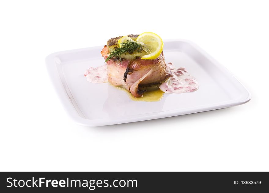 Meat with lemon and dill on white plate