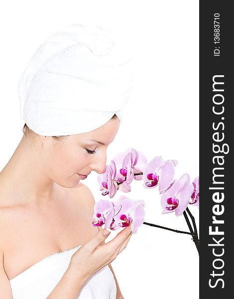 Caucasian woman with towel on head and violet orchids flowers. Caucasian woman with towel on head and violet orchids flowers