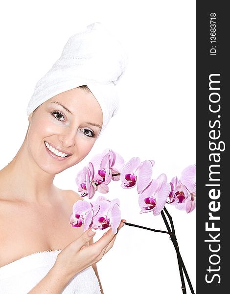 Caucasian woman with towel on head and violet orchids flowers. Caucasian woman with towel on head and violet orchids flowers