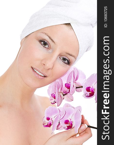 Caucasian woman with towel on head and violet orchids flowers. Caucasian woman with towel on head and violet orchids flowers