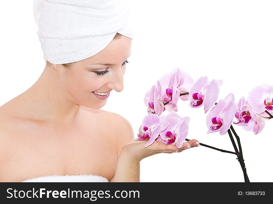 Caucasian woman with towel on head and violet orchids flowers. Caucasian woman with towel on head and violet orchids flowers