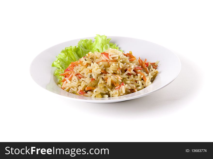 Pilaf on plate decorated with leaf on white ground