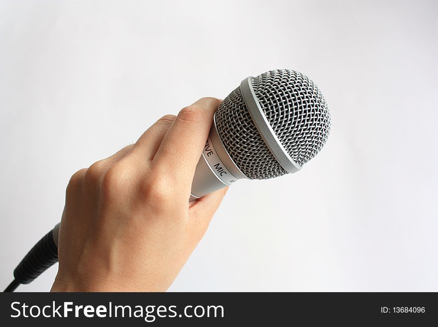 Metallic microphone in a hand