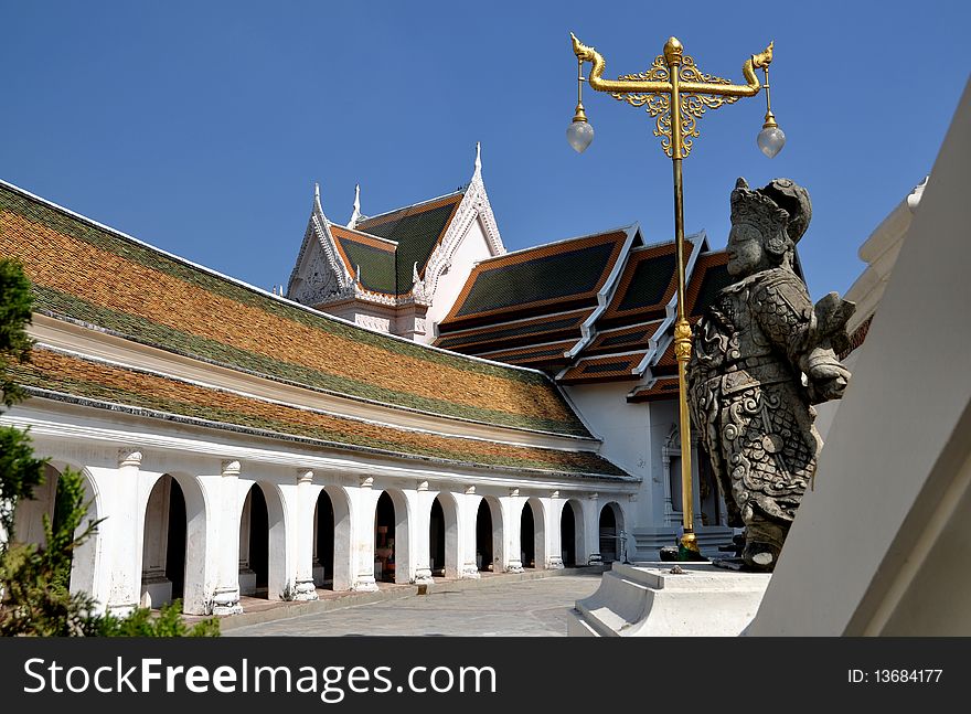 The graceful circular cloister gallery on the upper terrace surrounding the Phra Pathom Chedi temple and the imposing West Vihara in Nakhon Pathom, Thailand. The graceful circular cloister gallery on the upper terrace surrounding the Phra Pathom Chedi temple and the imposing West Vihara in Nakhon Pathom, Thailand.