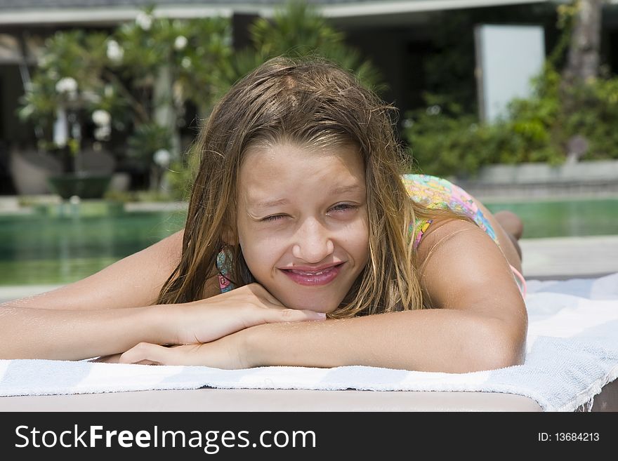 Girl portrait relaxing close to swimming pool at exotic surrounding, Asia.