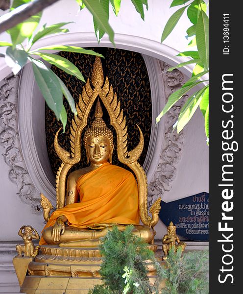 A serene, gilded Buddha sits in an alcove on the upper terrace circular cloister gallery at the Phra Pathom Chedi temple in Nakhon Pathom, Thailand. A serene, gilded Buddha sits in an alcove on the upper terrace circular cloister gallery at the Phra Pathom Chedi temple in Nakhon Pathom, Thailand.