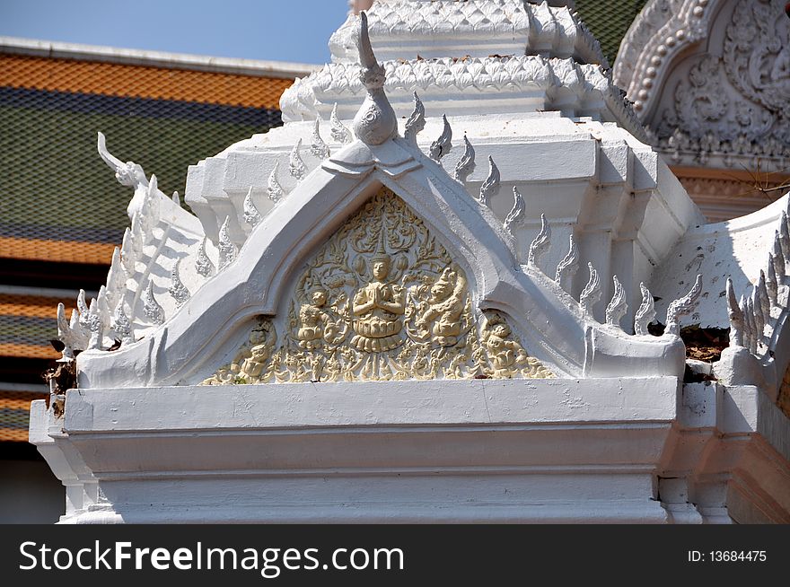 Detail of exquisite bas relief Buddha depiction on an ornate belfry on the upper terrace situated between the West and South Viharas at Phra Pathom Chedi in Nakhon Pathom, Thailand. Detail of exquisite bas relief Buddha depiction on an ornate belfry on the upper terrace situated between the West and South Viharas at Phra Pathom Chedi in Nakhon Pathom, Thailand.