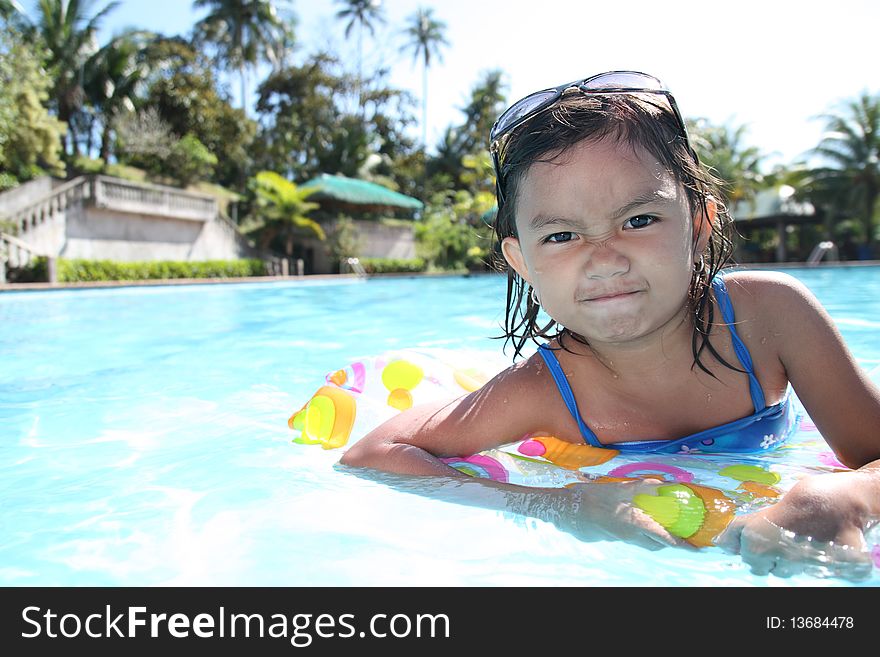 Young asian girl enjoying at the swimming pool. Young asian girl enjoying at the swimming pool