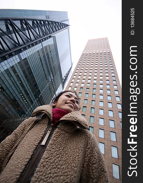 Young Japanese Girl In Front Of Buildings