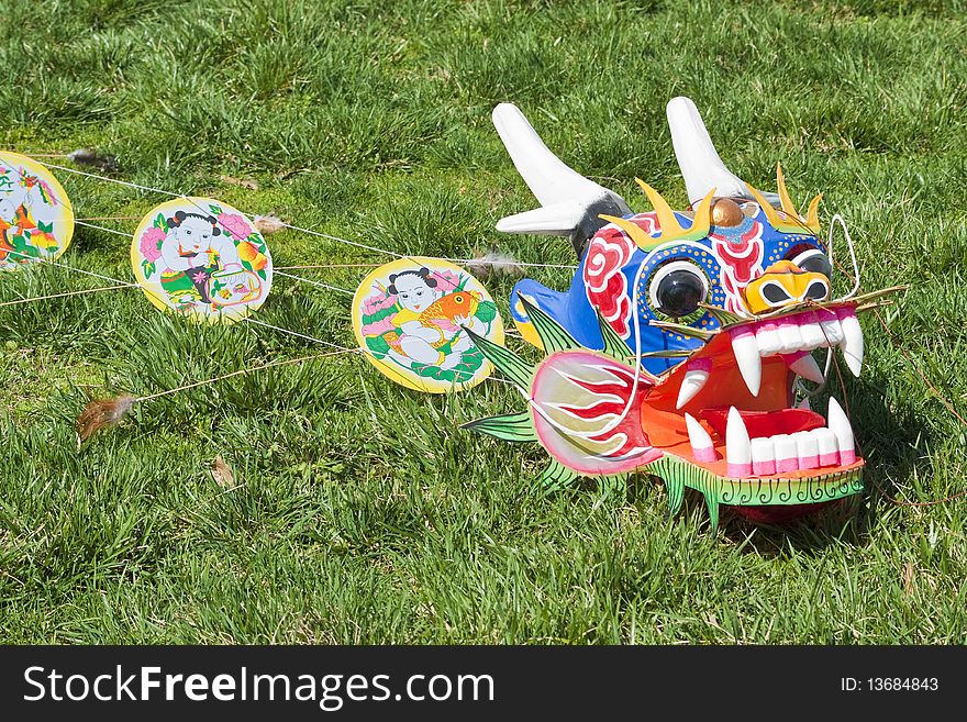 Colorful oriental dragon captured on a grassy surface. Colorful oriental dragon captured on a grassy surface.