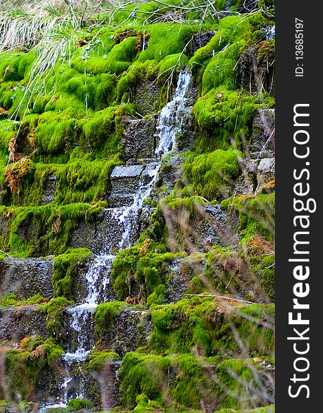 Waterfall on steps with green grass