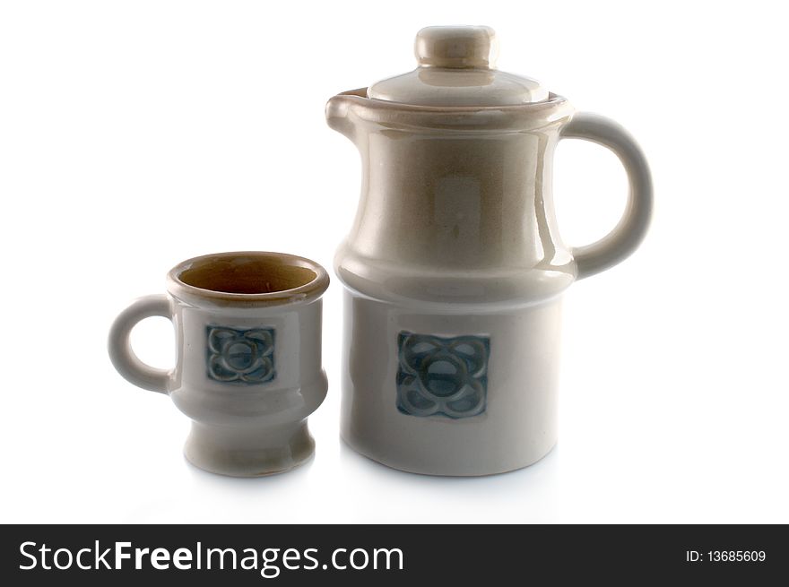 Ceramic mug and decanter on a white background