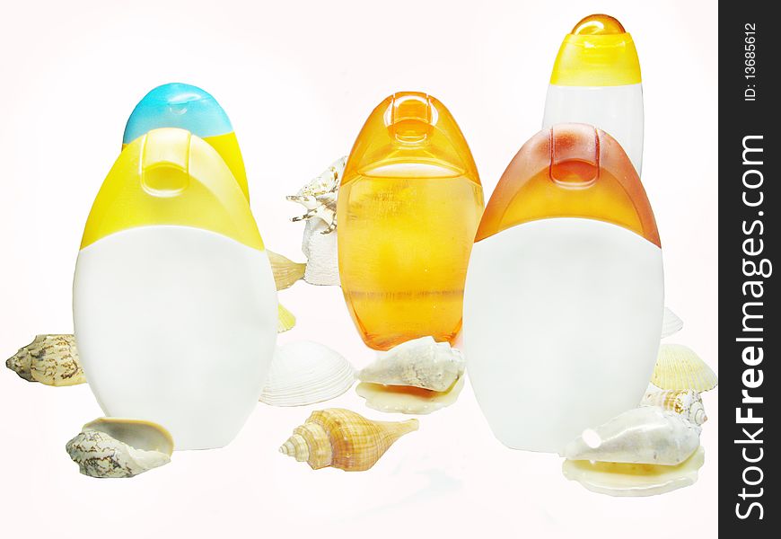Bottles of shampoo and shower gel among sea shells. Bottles of shampoo and shower gel among sea shells