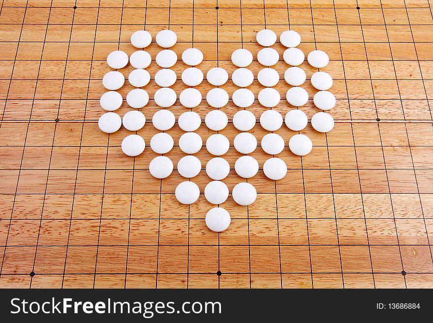 A white heart in a japanese Traditional go board. A white heart in a japanese Traditional go board