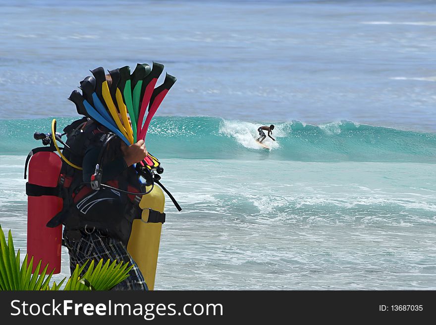 Diver with the colorful equipment on tropical beach . Diver with the colorful equipment on tropical beach .