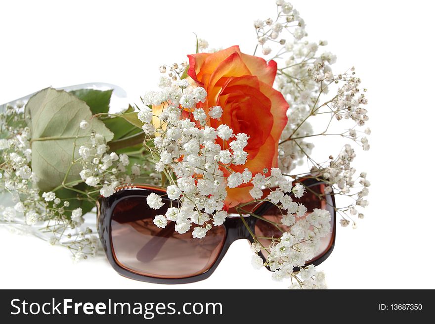 Sun glasses and bunch of flowers on a white background