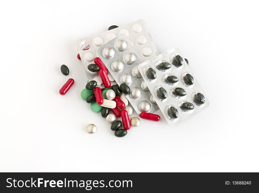 Pills scattered on white background