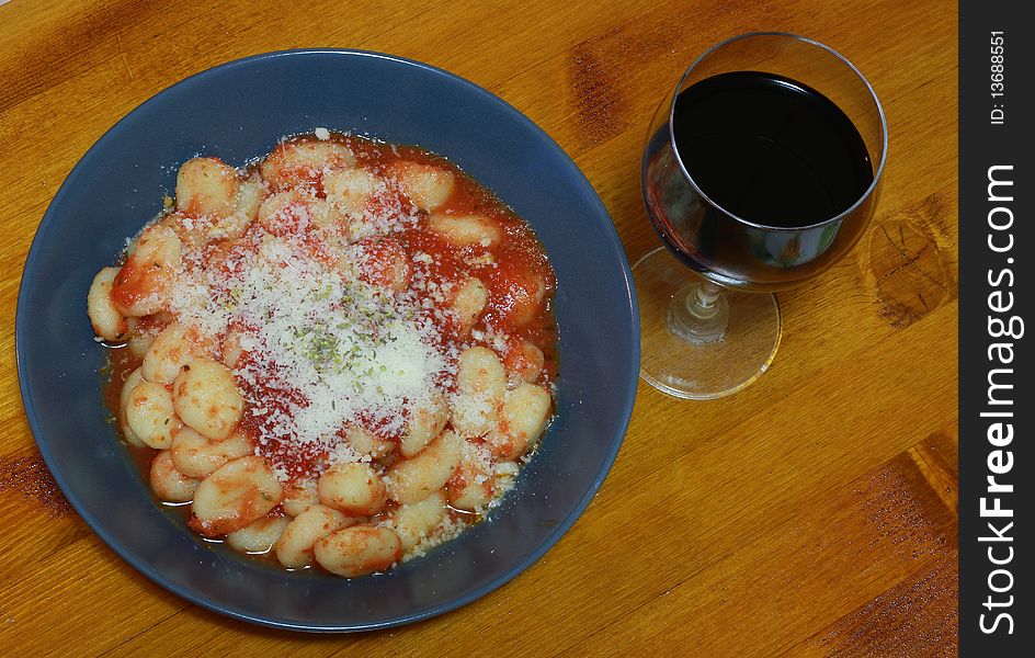 A dish of gnocchi with tomatoes sauce