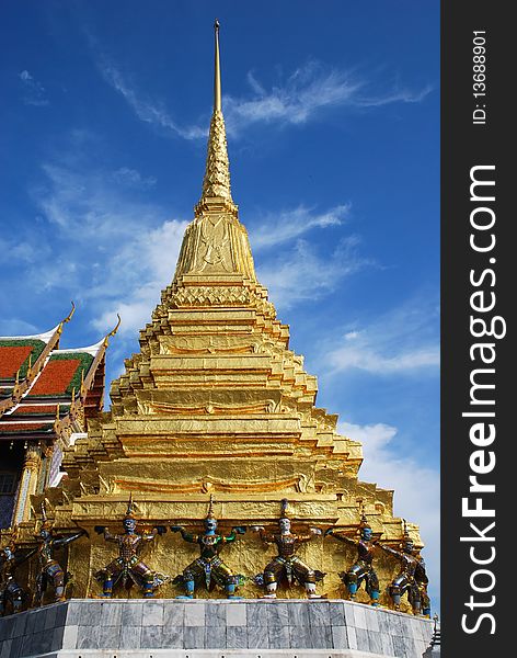 Gold pagoda and giant front of  Grand Palace Bangkok Thailand