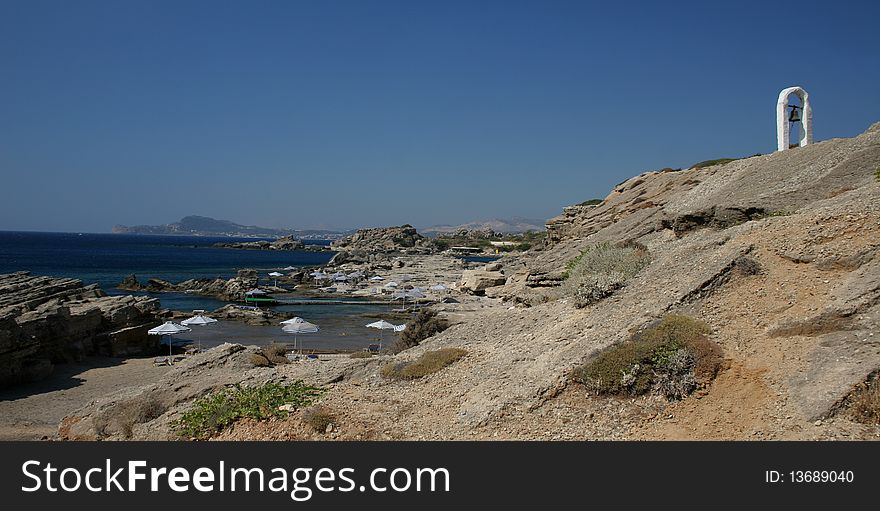 Kalithea beach with a bell tower in the island Rhodes in Greece
