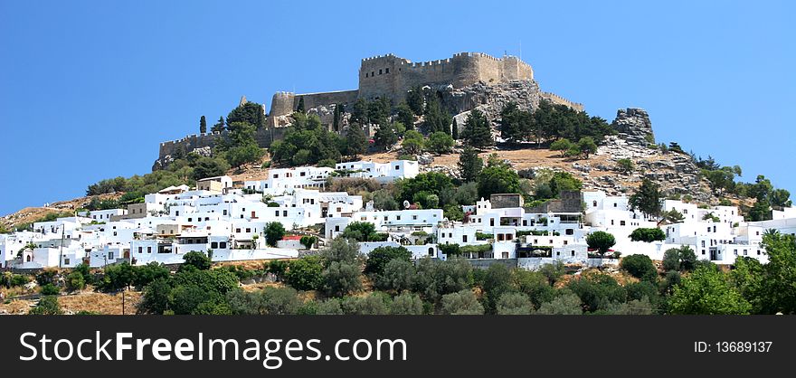 Lindos acropolis vwith a village below in Rhodes in Greece