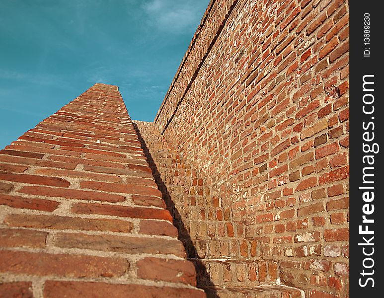 Grunge mysterious stairway made of red bricks