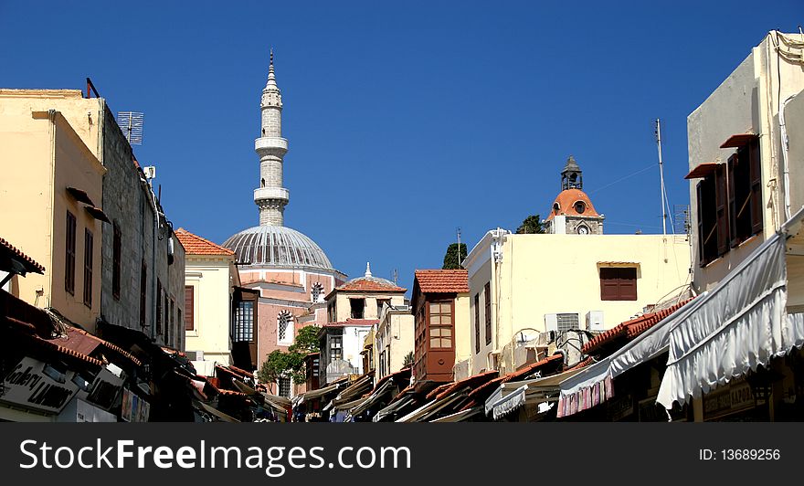 Mosque with a tower and sunshades in a street in Rhodes in Greece. Mosque with a tower and sunshades in a street in Rhodes in Greece