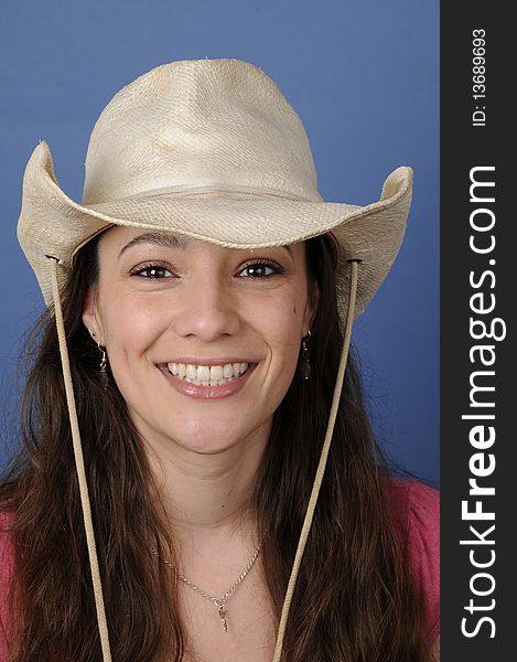 Woman is smiling with a cowboy hat. Woman is smiling with a cowboy hat