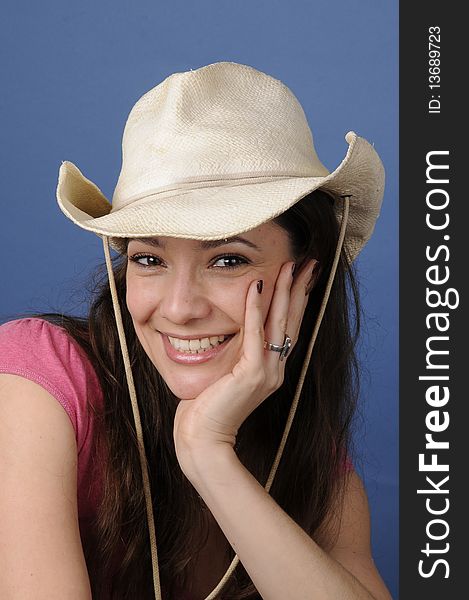 Woman is smiling with a cowboy hat. Woman is smiling with a cowboy hat
