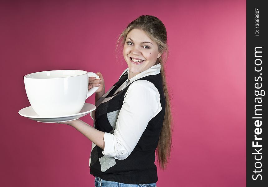 Young girl with extra large cup, studio