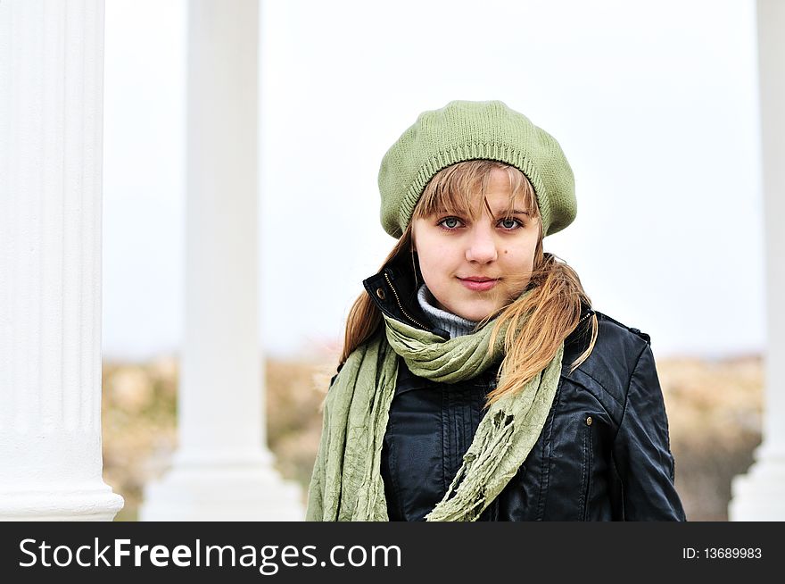 Teen girl wearing beret standing near the columns. Teen girl wearing beret standing near the columns