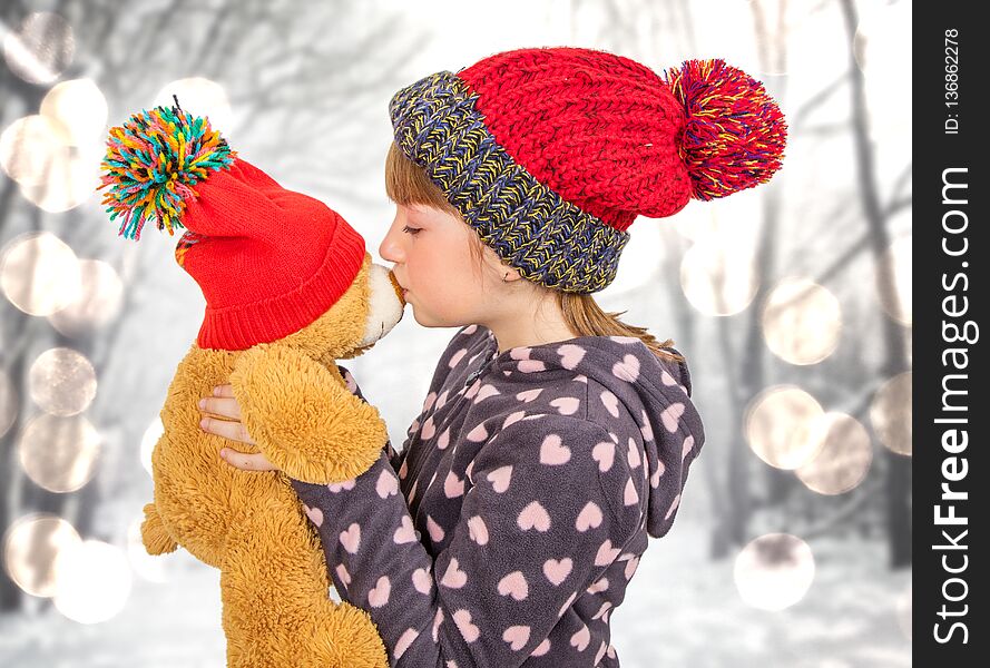 Young Girl Is Kissing Her Teddy Bear