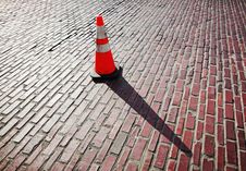 Traffic Cone On Brick Street Stock Photo Traffic Cone On Brick Street Stock Photo