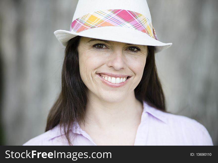 Portrait of a Smiling Young Woman Wearing a Hat. Portrait of a Smiling Young Woman Wearing a Hat