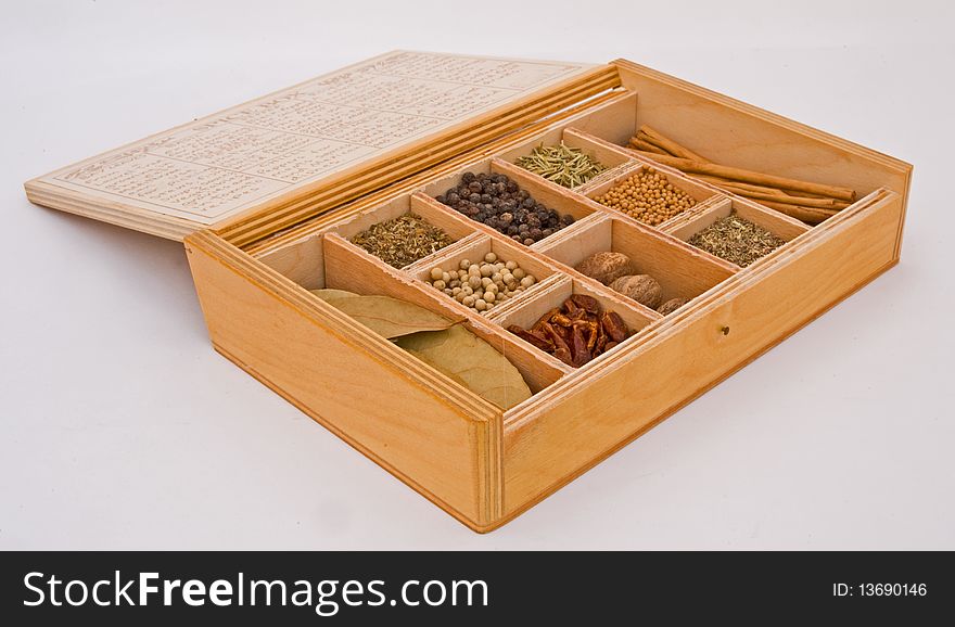 A macro image of a box containing a variety of spices isolated on a plain bright background. A macro image of a box containing a variety of spices isolated on a plain bright background.