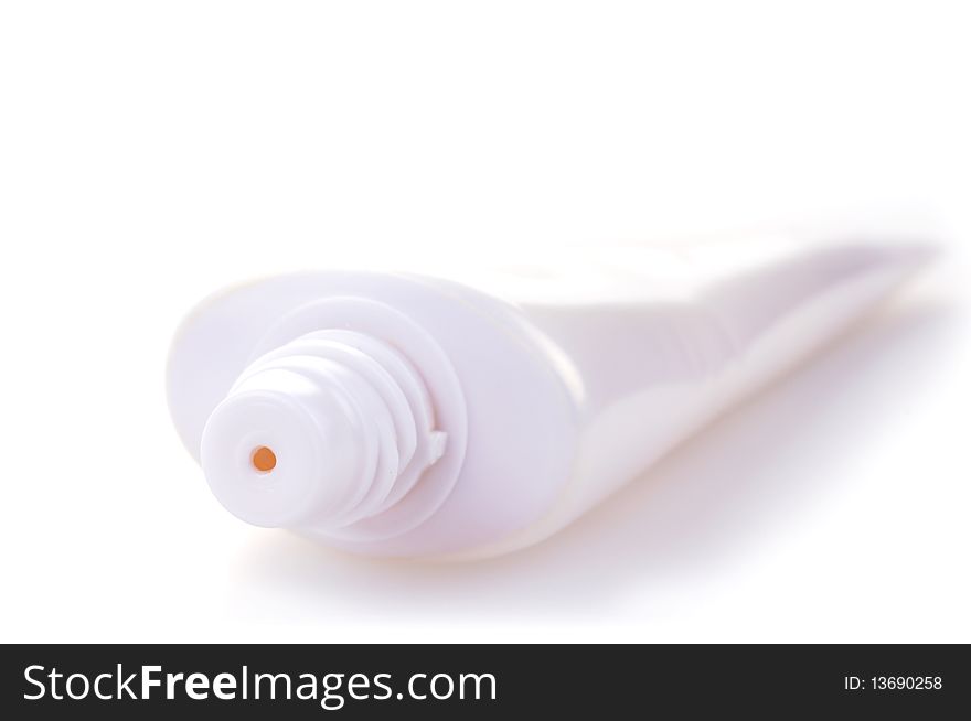 White tube of cream or other cosmetics in high key on white background. White tube of cream or other cosmetics in high key on white background