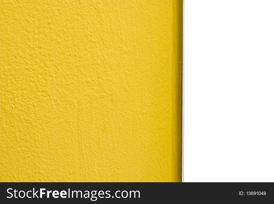 A yellow painted rough textured wall and smooth white plastic edge. A yellow painted rough textured wall and smooth white plastic edge