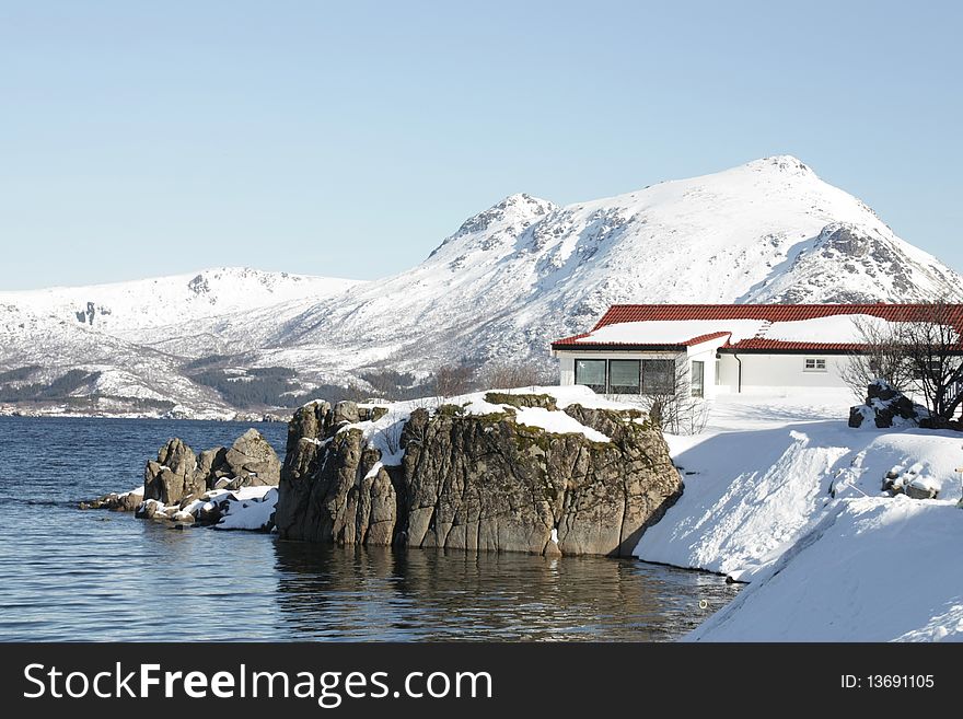 A lofoten's villa mirroring in Busknes fjord . A lofoten's villa mirroring in Busknes fjord