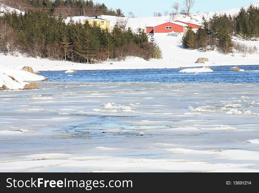 Red barn on the frozen Busknes fjord, Lofoen islands. Red barn on the frozen Busknes fjord, Lofoen islands