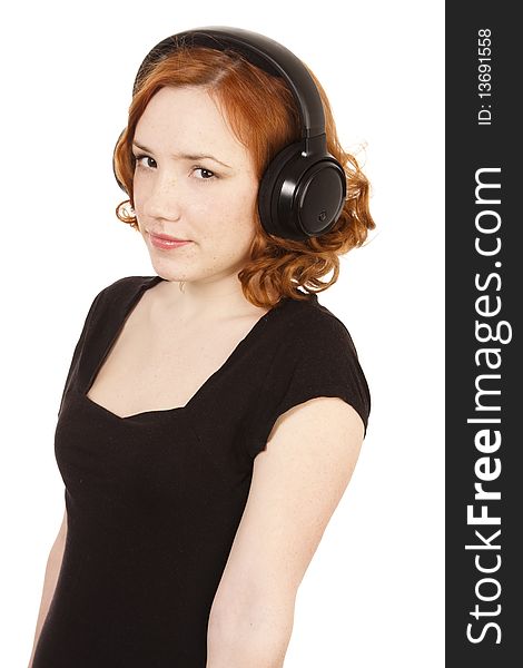 Redhead girl listening to music on headphones