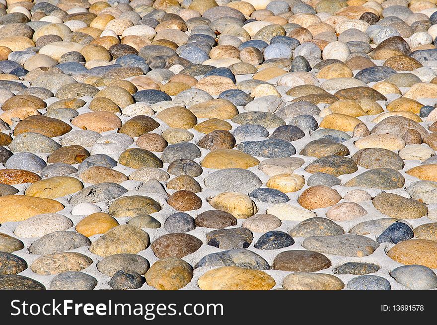 Pebbles stones pavement - background, texture