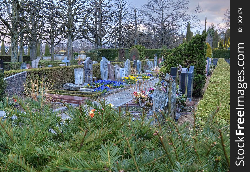 Colorful graveyard in Lausanne, Switzerland at dusk. An invitation to prayers, meditation and sacred thinking. Image in HDR. Colorful graveyard in Lausanne, Switzerland at dusk. An invitation to prayers, meditation and sacred thinking. Image in HDR.