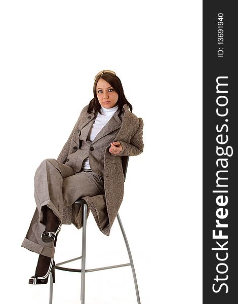 Sexy elegant business woman is posing on a chair